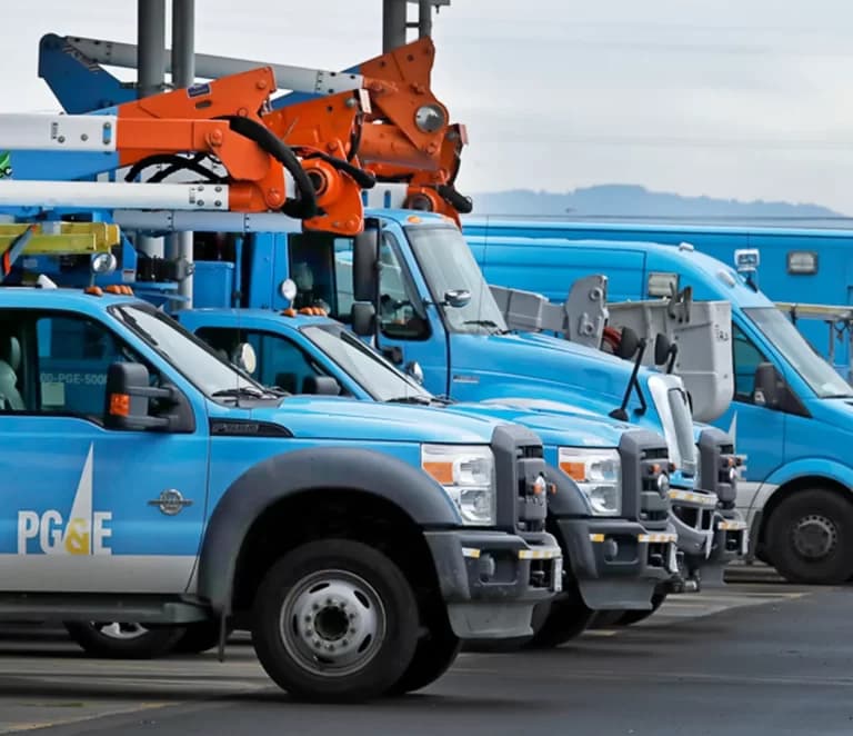 A row of fleet trucks and service vehicles at All Automatic Transmission