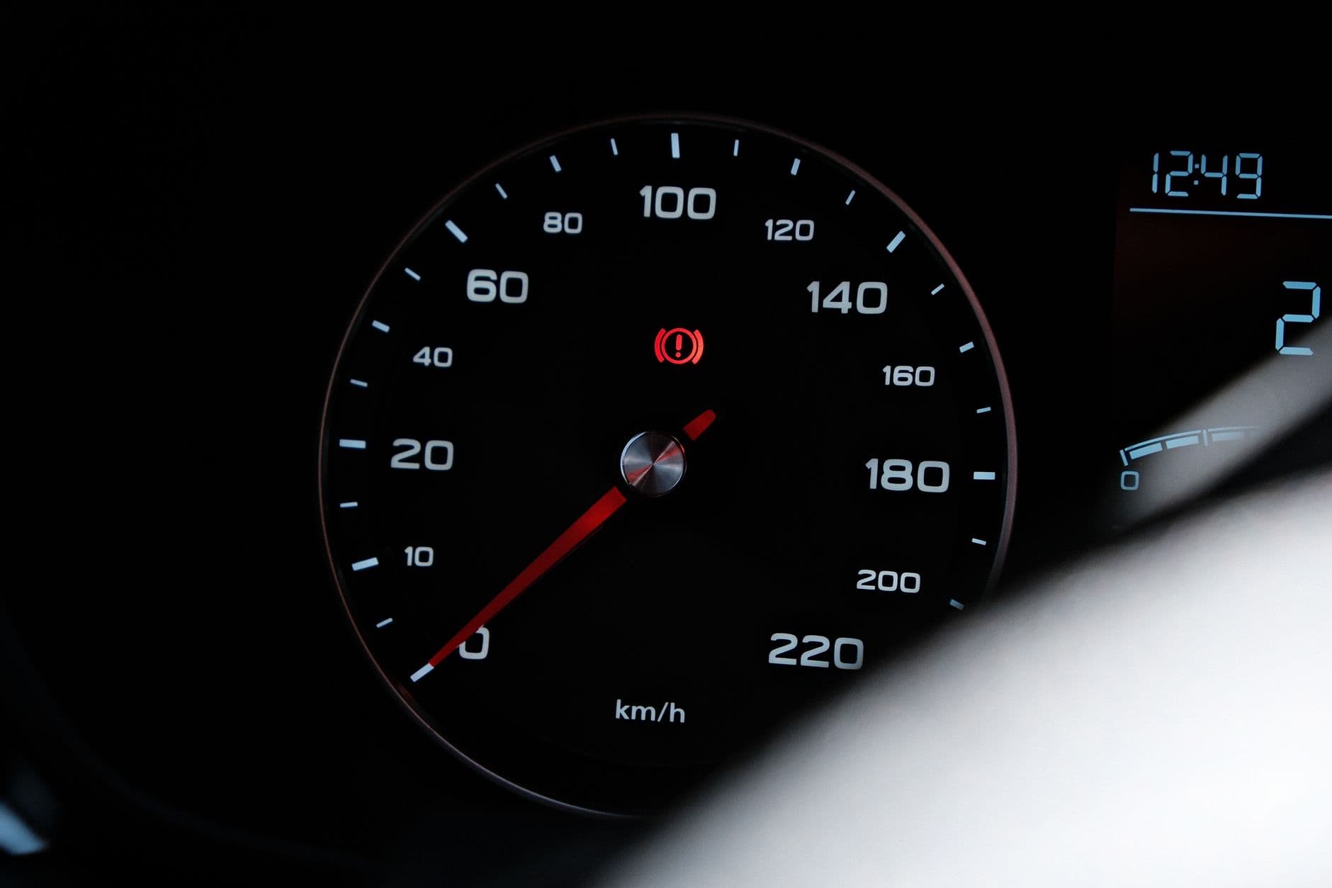A red warning light lit on a vehicle instrument cluster