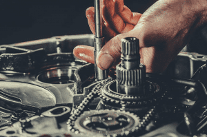 hands working on automatic transmission